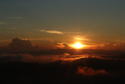Sunrise above clouds with golden light in Yercaud, India.